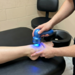 Physiotherapist applying Low Level Laser Therapy for ankle pain inflammation at Olive Physio Langley