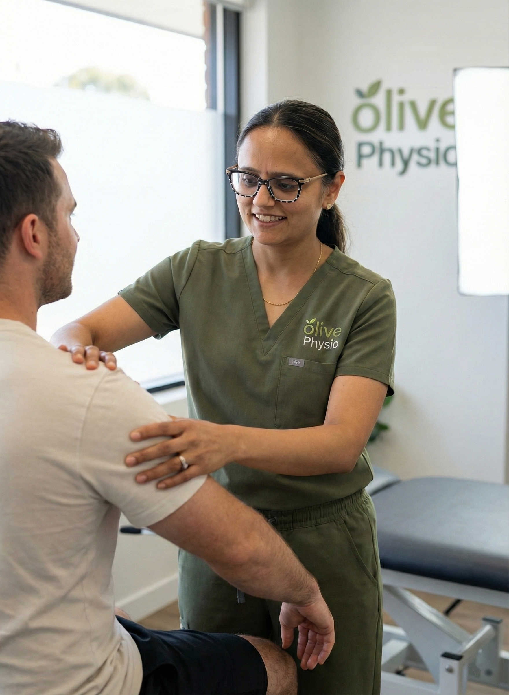 Physiotherapist assessing a patient's shoulder after a car accident for ICBC physiotherapy at Olive Physiotherapy in Langley City, BC